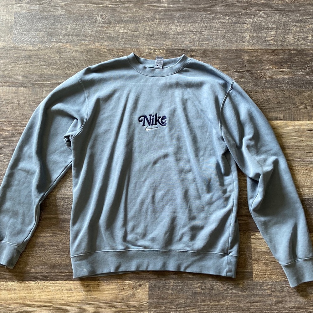 blue sweatshirt with embroidered nike symbol
